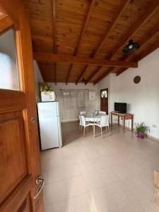 a kitchen with a table and a white refrigerator at Alvear Departamento B in Venado Tuerto