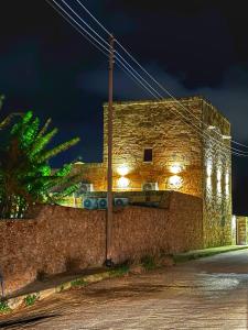 a brick building with lights on the side of it at Villa D'aragona Windmill in Għajnsielem