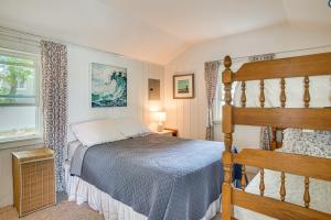 a bedroom with a bed and a window at Charming Cape Cod Water-View Cottage in Mashpee