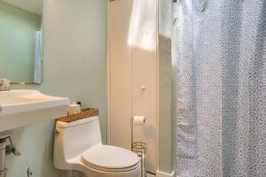a bathroom with a toilet and a sink and a shower at Charming Cape Cod Water-View Cottage in Mashpee +20 photos