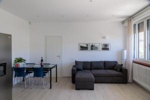 a living room with a couch and a table at Casa Flavia in Lierna