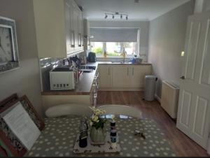 a small kitchen with a table and chairs and a table sidx sidx sidx at 2 Bedroom Garden Flat in Halesworth