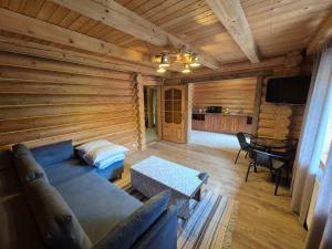 a living room with a couch and a table at Княжий двір in Yaremche