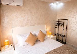 a bedroom with a large white bed with two lamps at Nador Skyline Al Matar in Nador