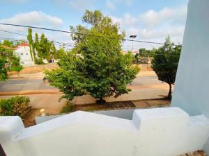 a view from a window of a street with a tree at Home & Heart Gambia in Brusubi