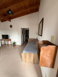 a large living room with a bed and a couch at Alvear Departamento B in Venado Tuerto