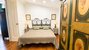 a bedroom with a bed and a large wooden door at The Queens House in Agrigento +26 photos