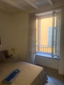 a bedroom with a bed and a window with a balcony at Jblago in Arona