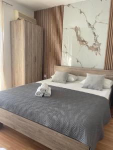 a bedroom with a bed with towels on it at New Apartments Blue in Ulcinj +13 photos