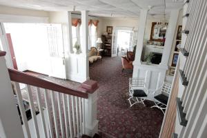 a room with a staircase and a living room at Hotel Macomber in Cape May