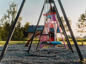 a swing set at a playground at Pokoje Gościnne Wróblówka in Laskowa