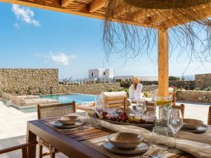 a table with a bowl of fruit on top of a house at Vendema Residence Mykonos in Mikonos