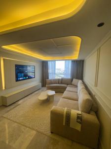 a living room with a couch and a tv at Hilton Tanger View Tower 15D in Tangier