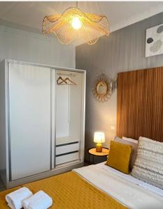 a bedroom with a bed and a chandelier at Casa da Susy do Alvão in Vila Real