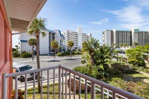 a balcony with a view of a street and buildings at Gulf Winds Resort by Travel Resort Services in St. Pete Beach