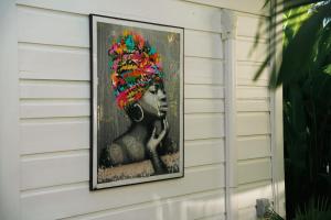 a picture of a woman with areath on a wall at Villa Zen - 1 Bedroom Studio in Saint James