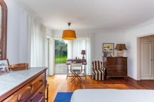 a bedroom with a desk and a table with a chair at Charming House in Cascais in Alcabideche +38 photos