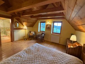 a bedroom with a bed and a desk and windows at Chalet Mates in Ždiar +36 photos