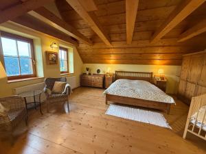 a bedroom with a bed and a wooden ceiling at Chalet Mates in Ždiar