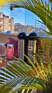 a table with two coffee pots and a plant at Hotel Aconchegante in Jequié