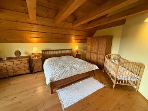a bedroom with a bed and a wooden ceiling at Chalet Mates in Ždiar