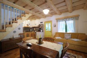 a living room with a couch and a table at Pompei Village in Cojocani
