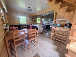 a kitchen and living room with a table and chairs at Mazury na Miedzy in Orzyny +20 photos