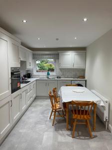 a kitchen with a table and chairs in it at CamCosy Retreat in Gortin