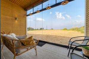 a porch with a couch and a view of the beach at Apartment Aurinkoranta D5 saunallinen kaksio merinäkymällä Kalajoki in Kalajoki