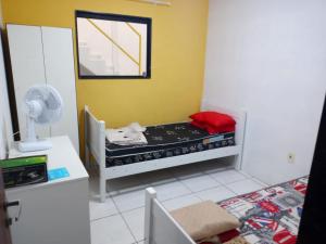 a small room with a bed and a fan at recanto sossego in Garanhuns
