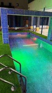a swimming pool with blue and green water at The bliss spot in Lekki