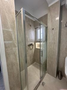 a shower with a glass door in a bathroom at Saranda Apartments in Sarandë +36 photos