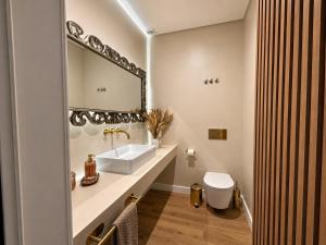 a white bathroom with a sink and a mirror at Vila apartment, free parking in Cascais +21 photos