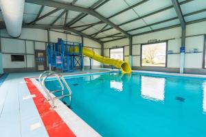 a large swimming pool with a slide in the middle at Casa Dana in Jaywick Sands