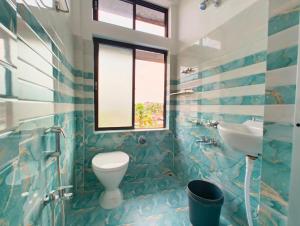 a bathroom with a toilet and a sink at Taj Heritage Hotel and Restaurant - Premium & Budget Rooms in Jorhāt