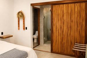 a bathroom with a shower and a wooden door at Casa Areka in Brisas de Zicatela