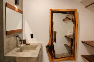 a bathroom with a large mirror and a sink at Casa Areka in Brisas de Zicatela