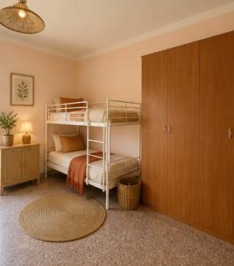 a bedroom with two bunk beds and a cabinet at Casa Vacanze Panoramika Santa Cruz - Appartamento PANORAMIKA in Cicerale