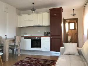 a kitchen with a couch and a table in a room at nKulle in Boge