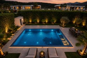 a swimming pool in the middle of a yard at night at Villa Krasta in Elbasan