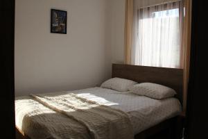 a bedroom with a bed with a window and a bedspread at nKulle in Boge +38 photos