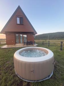 a large hot tub in front of a house at Zabljak villa VAM in Žabljak