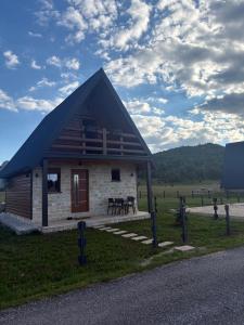 a small building with a roof on the side of a road at Zabljak villa VAM in Žabljak