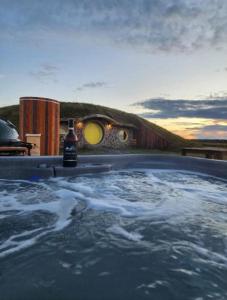 a bath tub with water in it with a sunset in the background at Terra Experience in Shippagan