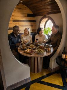 a group of people sitting around a table with wine glasses at Terra Experience in Shippagan