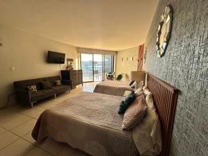 a large bedroom with two beds and a couch at By the sea Condominium in San Carlos