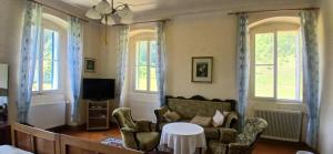 a living room with a couch and chairs and a tv at Gasthaus Kopper in Guttaring