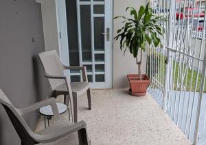 a porch with two chairs and a potted plant at Sun Seekers Retreat 3 bedrooms in Santa Maria