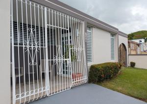 a gate on the side of a house at Sun Seekers Retreat 3 bedrooms in Santa Maria