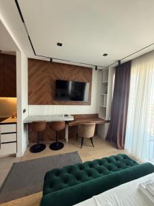 a bedroom with a bed and a desk with a television at BW LUX STUDIO-Belgrade Waterfront in Belgrade